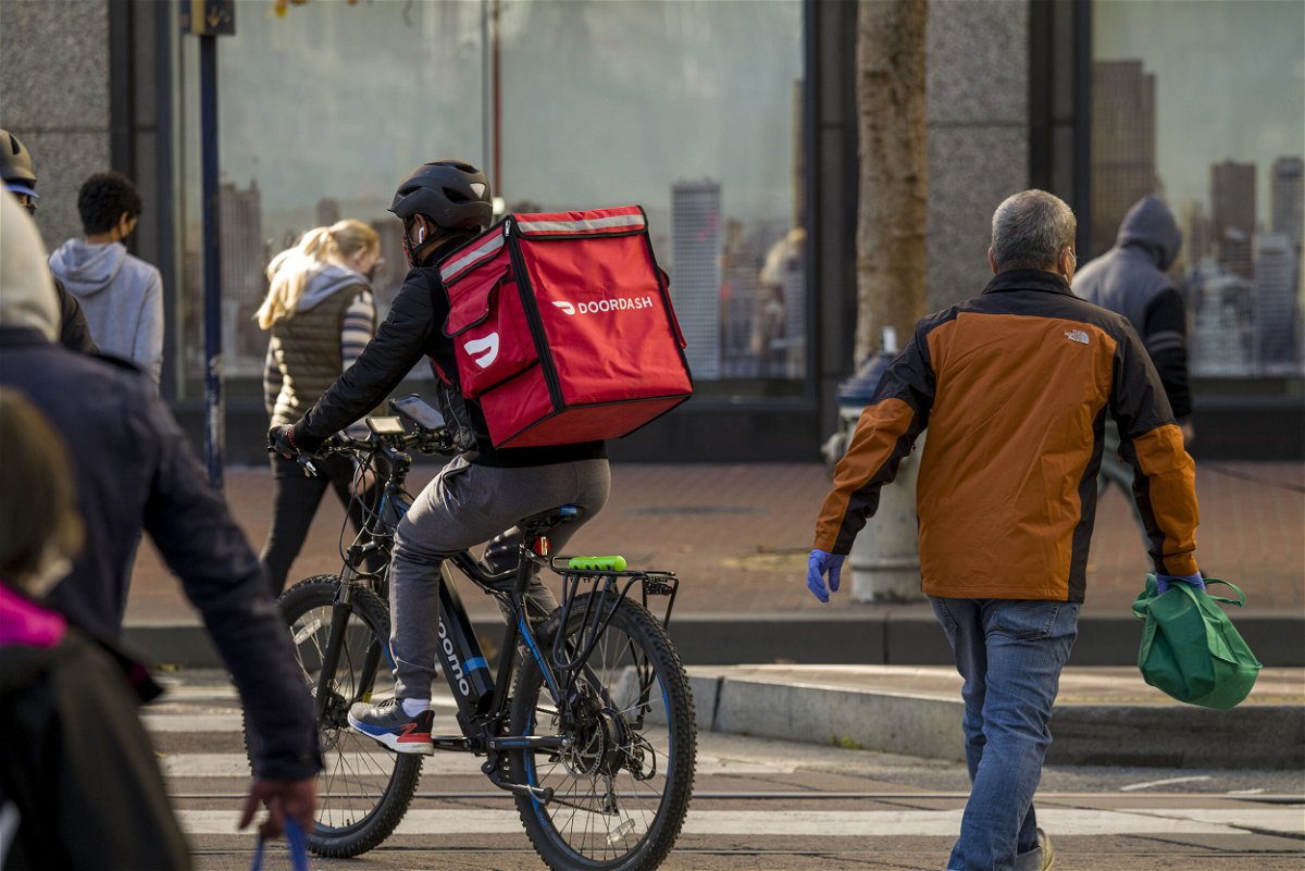 <i>David Paul Morris/Bloomberg/Getty Images</i><br/>A bike messenger carries a DoorDash Inc. bag in San Francisco