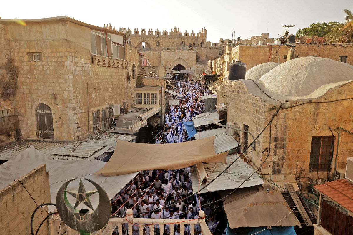 <i>Hazem Bader/AFP/Getty Images</i><br/>Demonstrators gather with Israeli flags after crossing through the Damascus Gate on May 29.