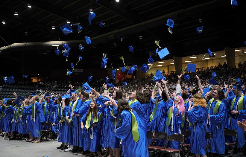 Redmond Proficiency Academy Class of '22 tosses caps in the air at ceremony