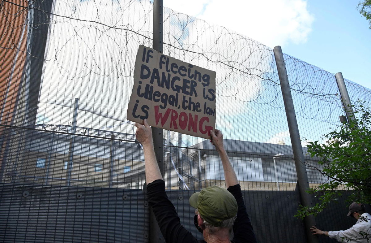 <i>Toby Melville/Reuters</i><br/>Demonstrators protest outside of Brook House Immigration Removal Centre against a planned deportation of asylum seekers from Britain to Rwanda