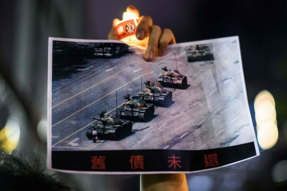<i>Anthony Wallace/AFP/Getty Images</i><br/>A man holds a poster of the famous 'Tank Man' who stood in front of Chinese military tanks at Tiananmen Square in Beijing in 1989.