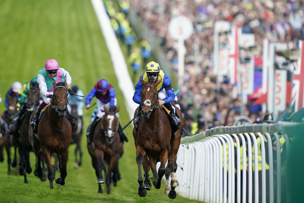 <i>Alan Crowhurst/Getty Images Europe/Getty Images</i><br/>Richard Kingscote riding Desert Crown wins the Epsom Derby.