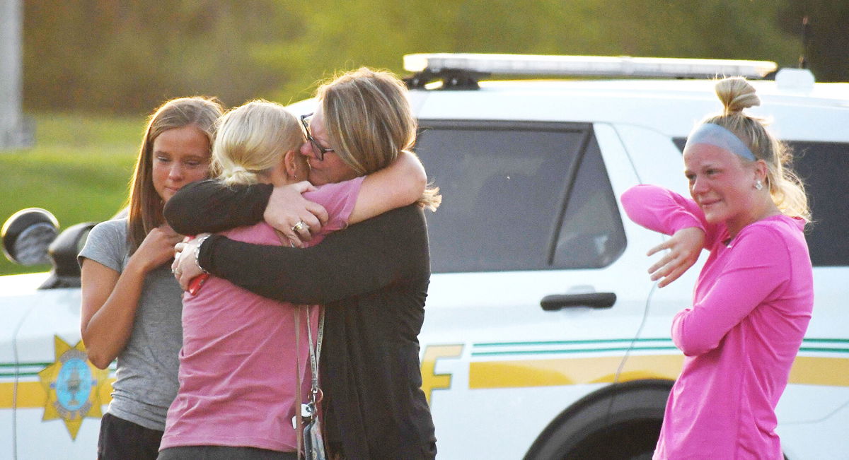 <i>Nirmalendu Majumdar/USA Today Network/Reuters</i><br/>People console each other after a shooting outside Cornerstone Church in Ames