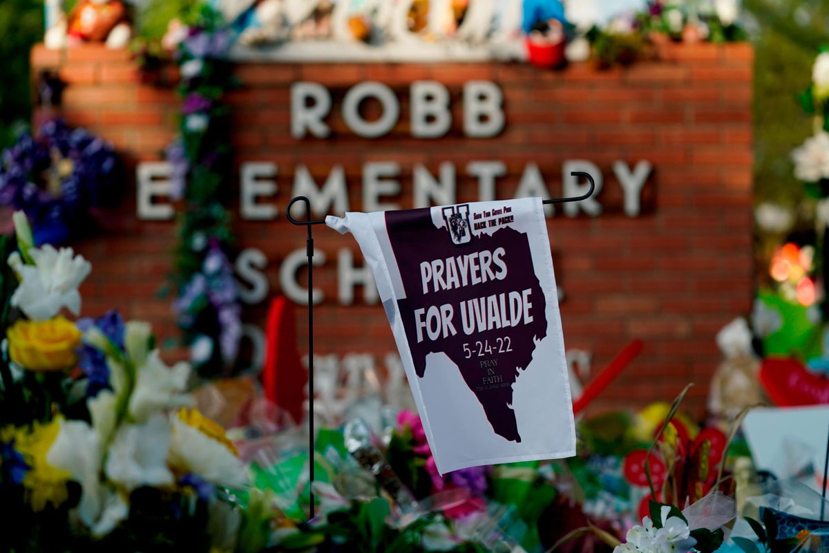 <i>Eric Gay/AP</i><br/>A banner hangs at a memorial outside Robb Elementary School to honor the victims killed in last week's school shooting