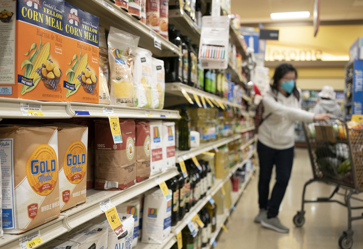 <i>Liu Guanguan/China News Service/Getty Images</i><br/>Bags of wheat flour and corn flour are on sale at a supermarket on April 9