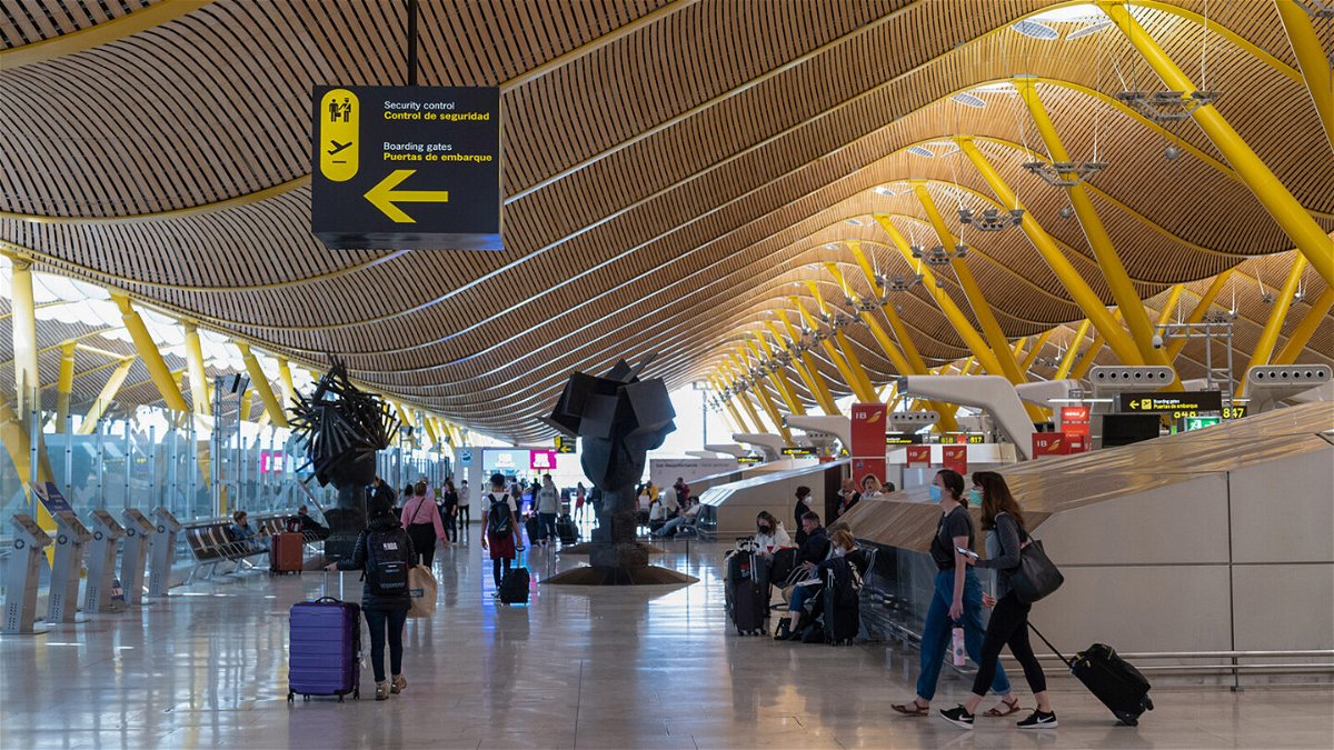 <i>Emilio Parra Doiztua/Bloomberg/Getty Images</i><br/>Passengers wait in the departures hall at Madrid Barajas Airport in Spain earlier this year.