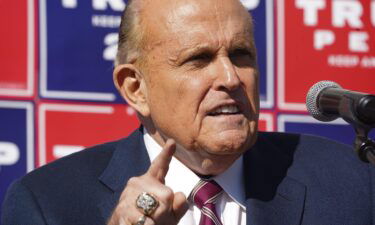 Rudy Giuliani speaks at a news conference in the parking lot of a landscaping company on November 7