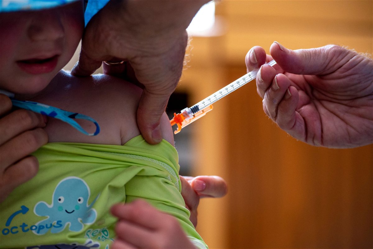 <i>JOSEPH PREZIOSO/AFP/AFP via Getty Images</i><br/>A three-year-old receives the Covid-19 vaccination in Needham