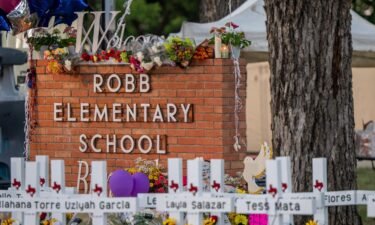 A memorial is seen surrounding the Robb Elementary School sign  on May 26