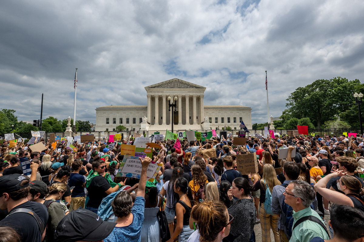 <i>Brandon Bell/Getty Images</i><br/>People protest in response to the Dobbs v Jackson Women's Health Organization ruling in front of the U.S. Supreme Court on June 24.
