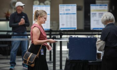 Harper Brown of Denver turns in her ballot as she votes on June 28. Republicans in Colorado rejected a 2020 election denier to be their next secretary of state.