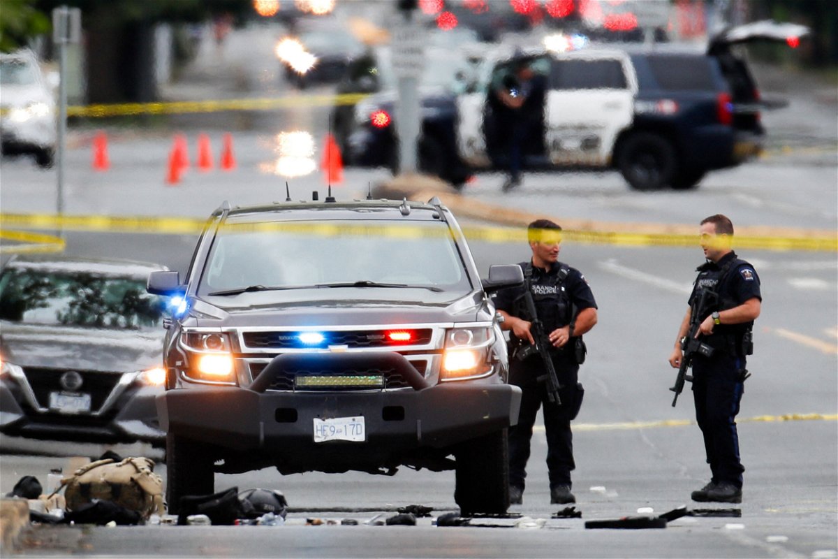 <i>Kevin Light/Reuters</i><br/>Police officers gather at the scene of a shootout in Saanich