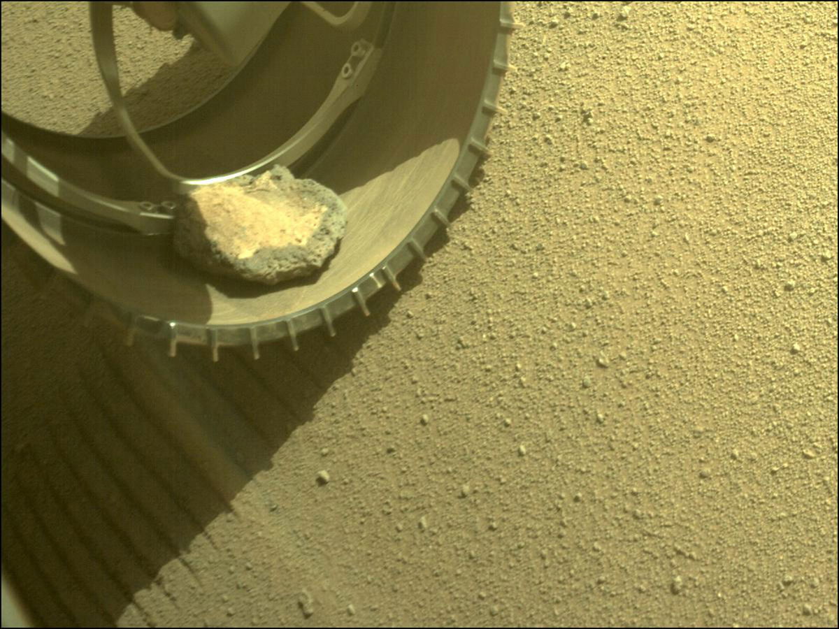 <i>NASA/JPL-Caltech</i><br/>The Mars Perseverance rover gained a new traveling companion when a rock hopped into its wheel four months ago while it explored Jezero Crater.