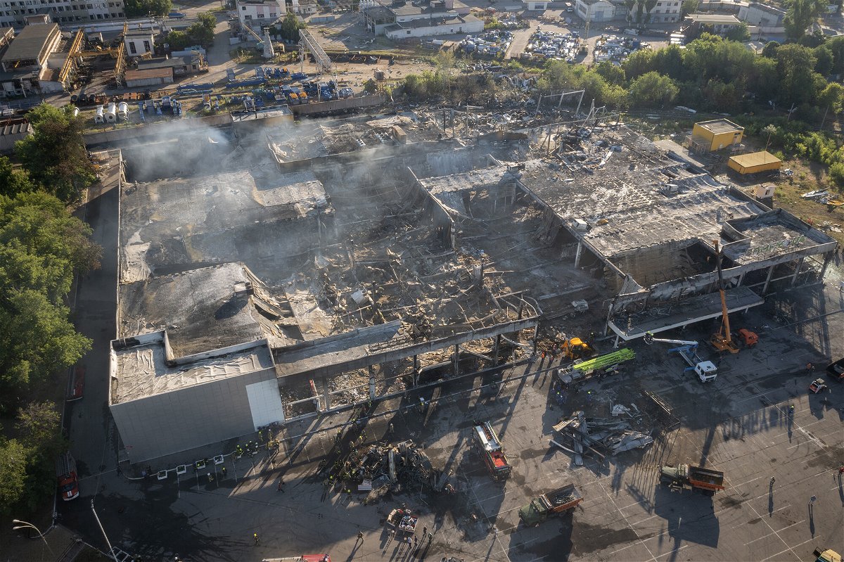 <i>Efrem Lukatsky/AP</i><br/>Firefighters work to remove debris at a shopping center burned after a rocket attack in Kremenchuk