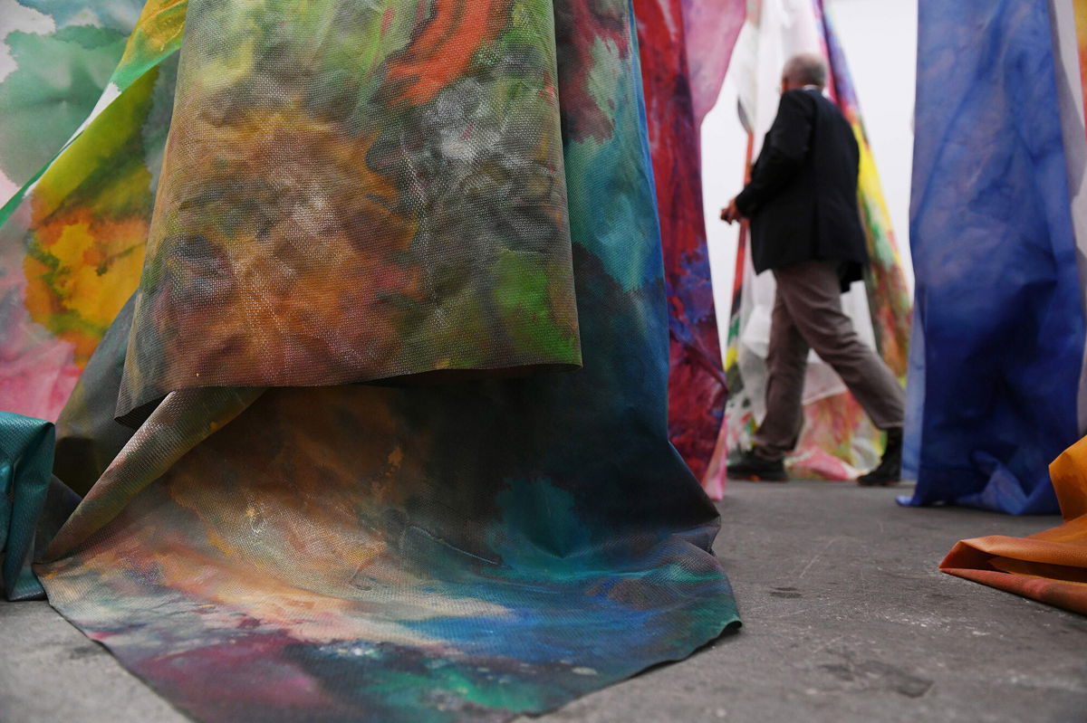 <i>Sebastian Bozon/AFP/Getty Images</i><br/>A man walks past Gilliam's work 