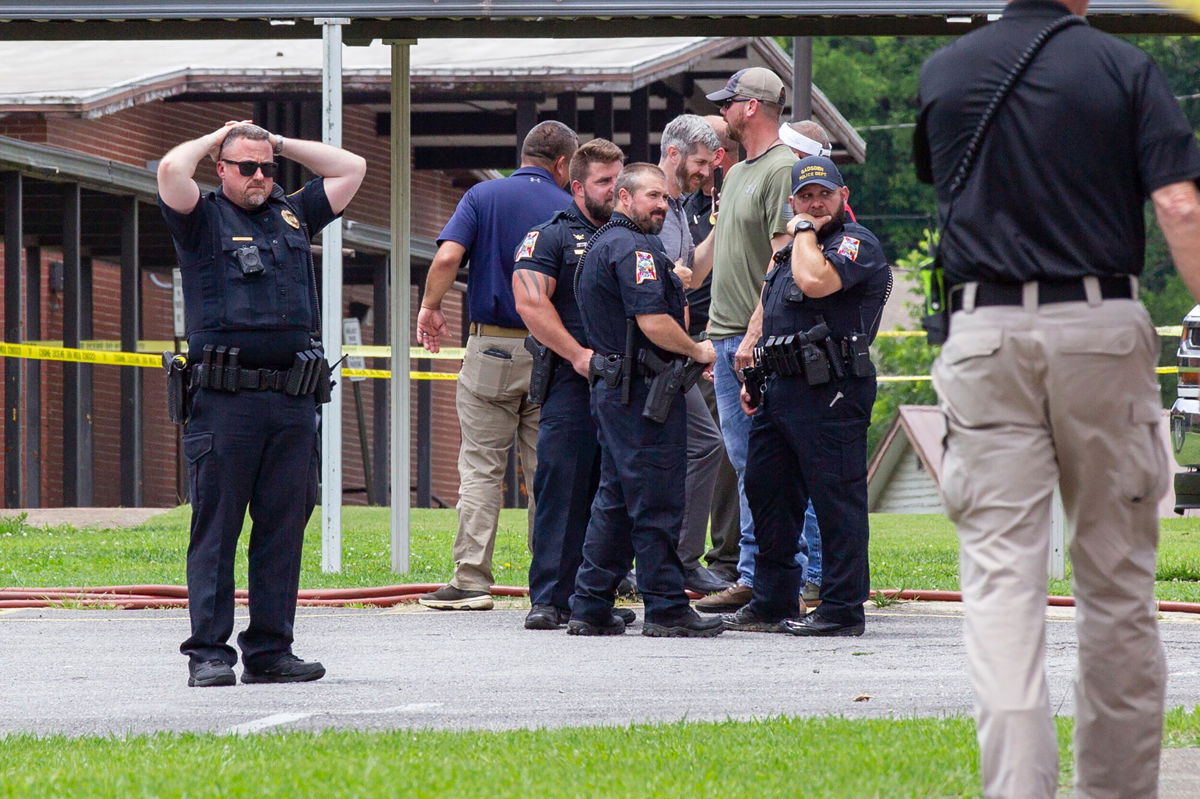 <i>Jesse Jarrold-Grapes/The Gadsden Time/AP</i><br/>Officials gather outside Walnut Park Elementary School in Gadsden