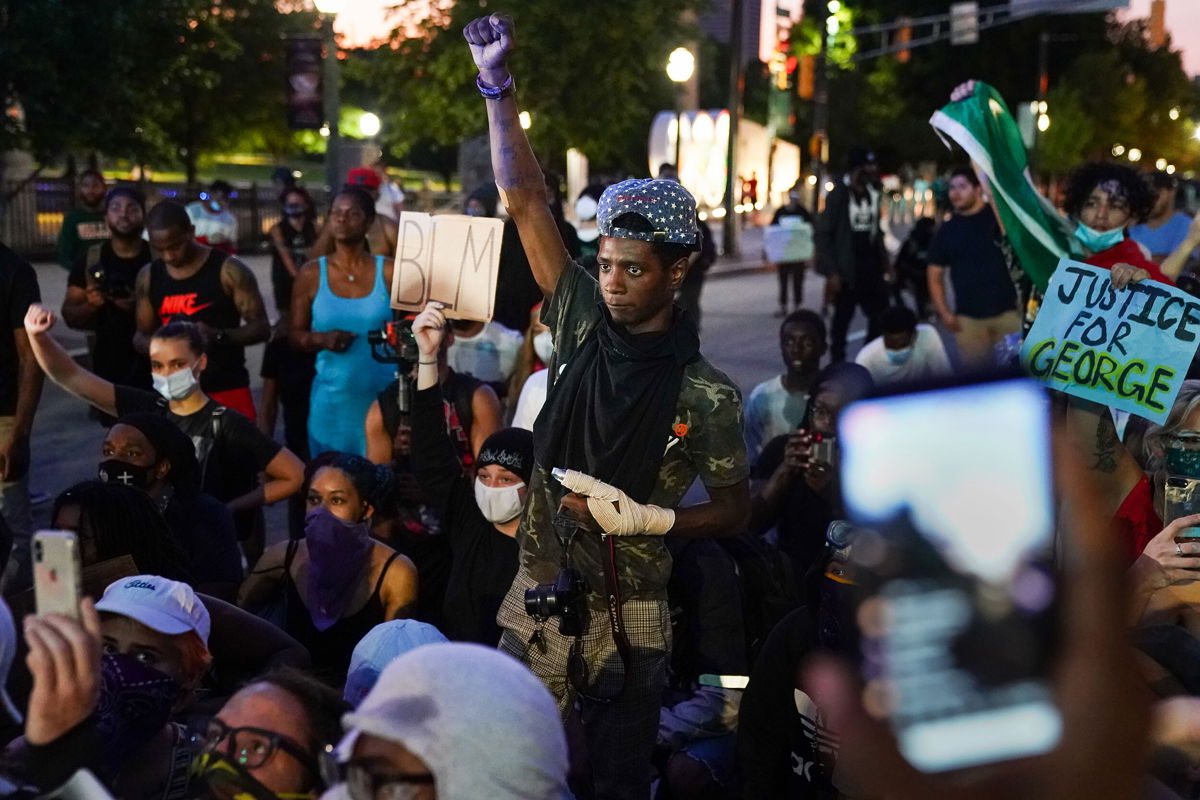 <i>Elijah Nouvelage/Getty Images</i><br/>A protester raises his fist during a demonstration on May 31