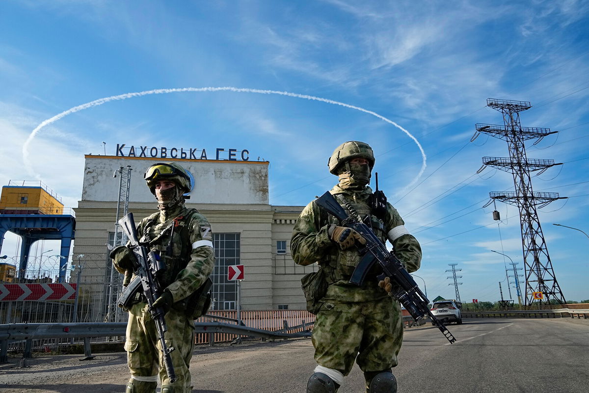 <i>AP</i><br/>Russian troops guard an entrance of a Kakhovka power plant in southern Ukraine