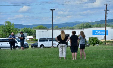 A Washington County Sheriff's Office deputy talks to bystanders following a shooting in Smithsburg