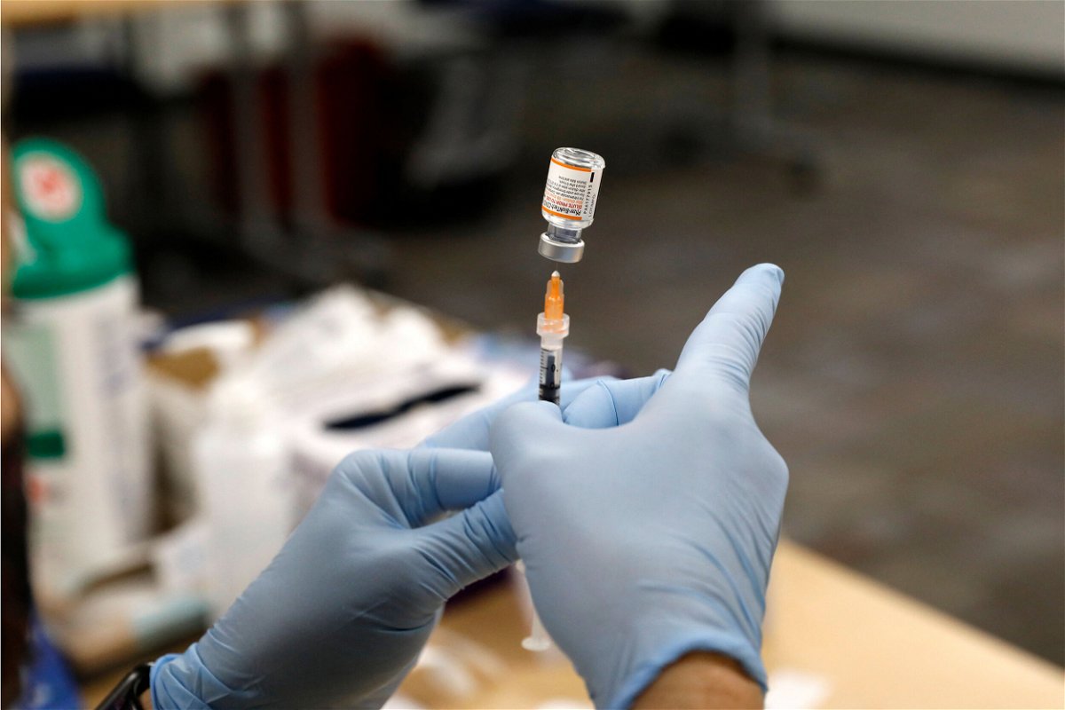 <i>Jeff Kowalsky/AFP/Getty Images</i><br/>Nurse practitioner Sarah Rauner fills a syringe with the Pfizer Covid-19 vaccine to be administered to children from 5-11 years old are seen at the Beaumont Health offices in Southfield