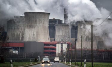 Smoke and vapor rising from the cooling towers and chimneys of a lignite-fired power plant near Bergheim