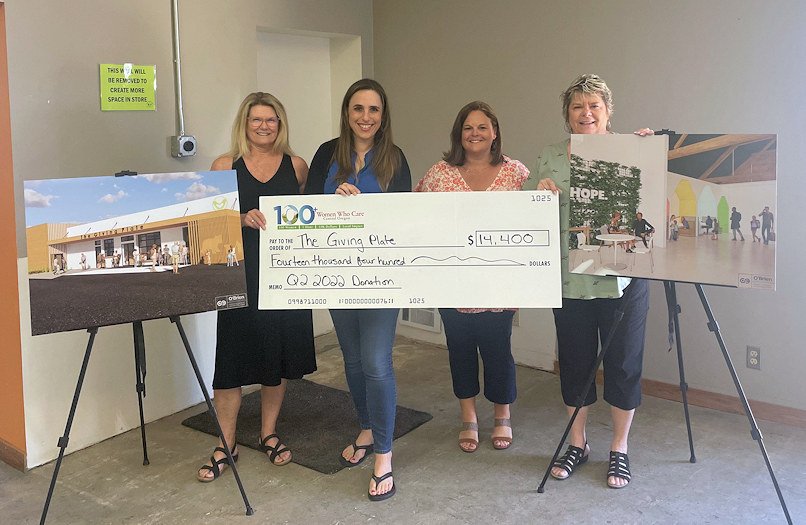 Christi Haynes, 100+ Women Who Care, Ranae Staley, Executive Director, The Giving Plate, Kristin Betschart, 100+ Women Who Care, Cindy Bahr-Merrill, 100+ Women Who Care at check presentation at The Giving Plate's new building