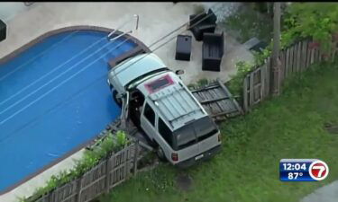 An SUV collided with a fence and stopped inches above the water of a backyard pool in Dania Beach