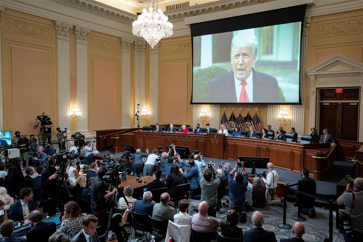 <i>Alex Brandon/Pool/Reuters</i><br/>A video of former President Donald Trump is shown on a screen