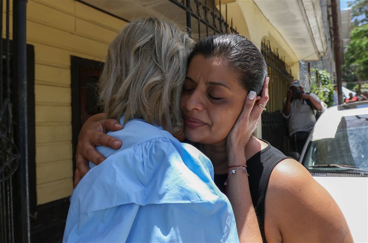 <i>Delmer Martinez/AP</i><br/>Karen Caballero is comforted during an impromptu conference at her home in Las Vegas