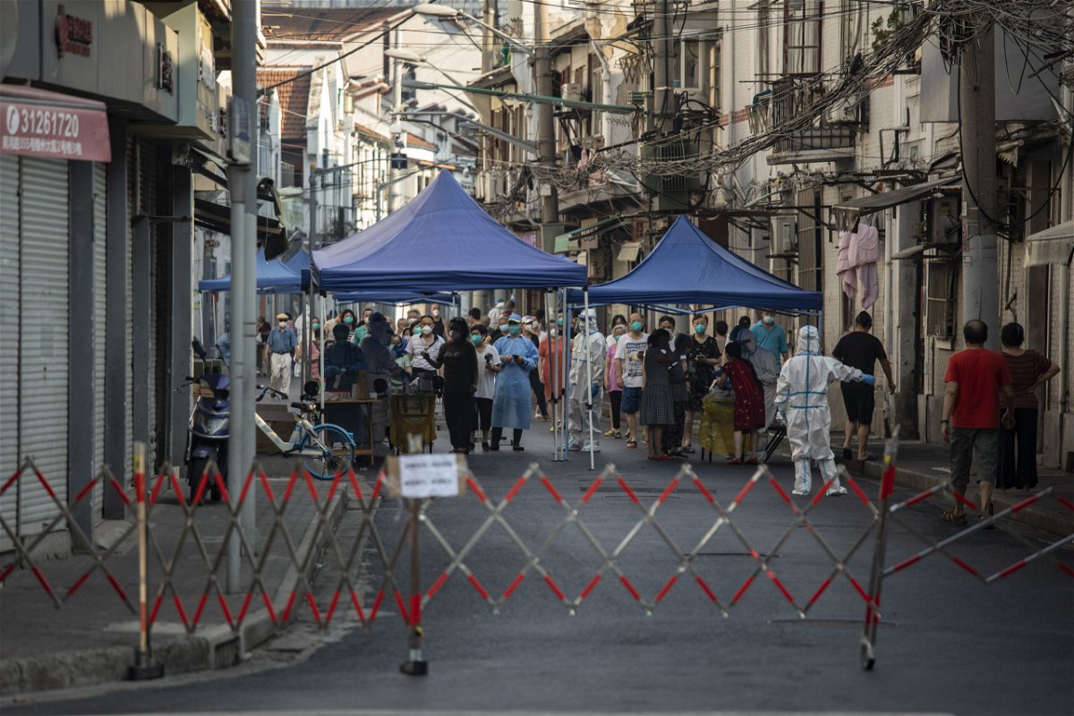 <i>Qilai Shen/Bloomberg/Getty Images</i><br/>Shanghai residents line up for Covid tests in a locked down neighborhood on July 10.