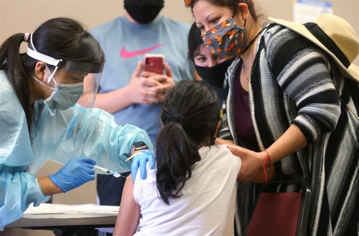 <i>Mario Tama/Getty Images</i><br/>A girl receives the flu vaccination shot from a nurse at a free clinic held at a local library on October 14