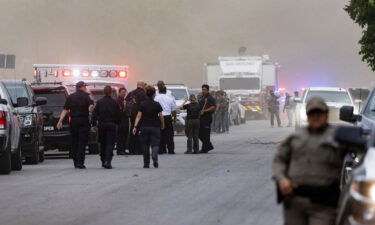 Law enforcement work the scene after a mass shooting at Robb Elementary School where 19 people