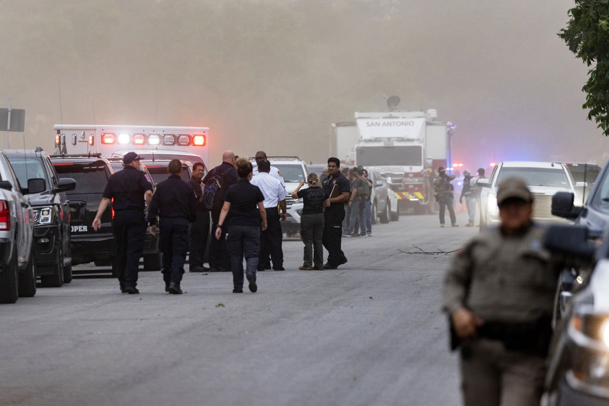 <i>Jordan Vonderhaar/Getty Images North America/Getty Images</i><br/>Law enforcement work the scene after a mass shooting at Robb Elementary School where 19 people