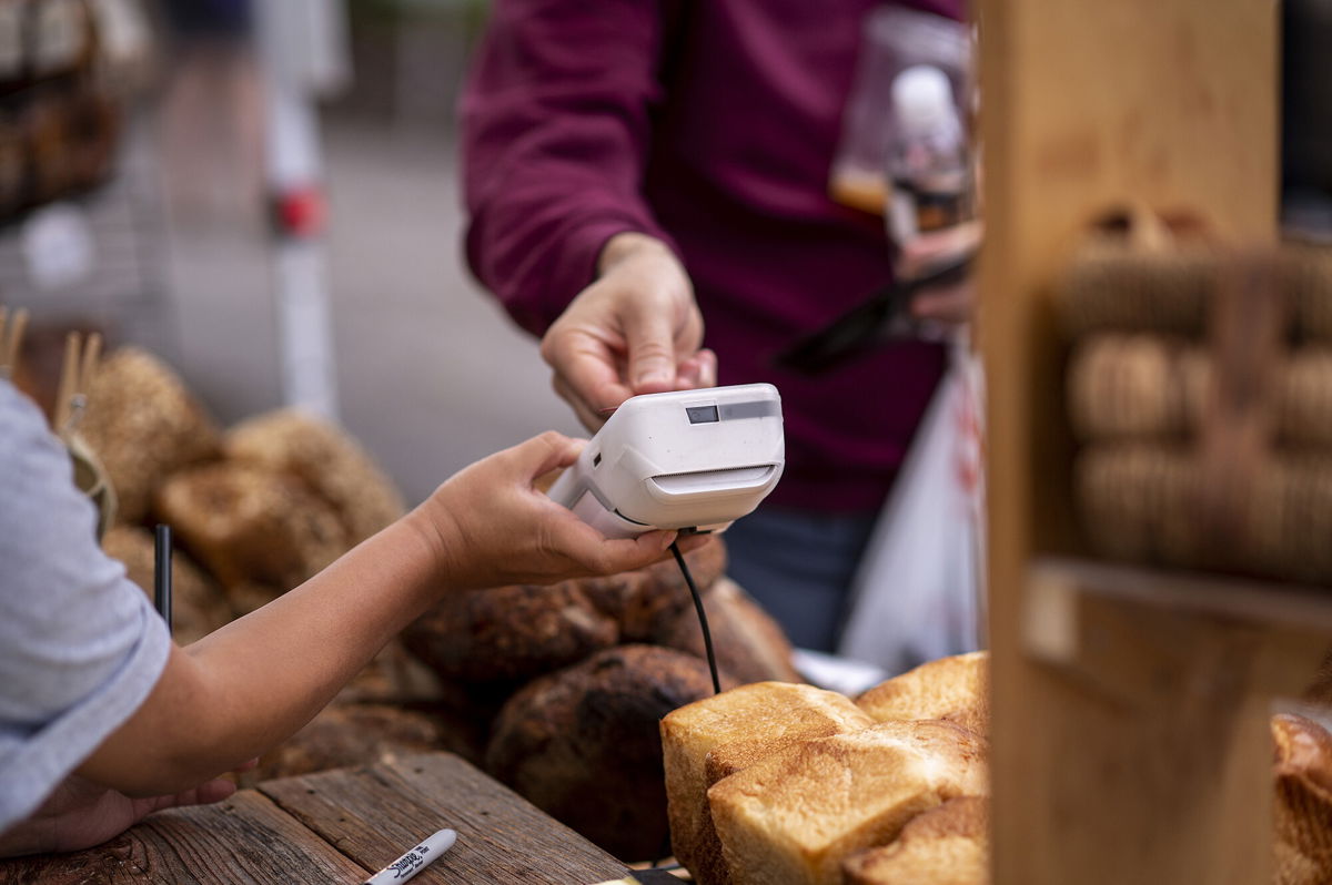 <i>Christopher Dilts/Bloomberg/Getty Images</i><br/>A customer purchases at a farmers market in Chicago