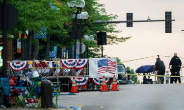 A body is transported from the scene of a mass shooting during the July 4th holiday weekend in Highland Park