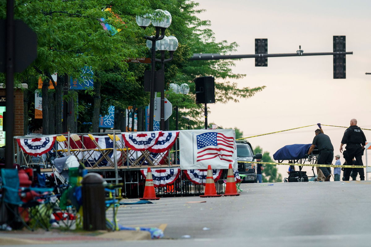 <i>Armando L. Sanchez/Chicago Tribune/AP</i><br/>A body is transported from the scene of a mass shooting during the July 4th holiday weekend in Highland Park