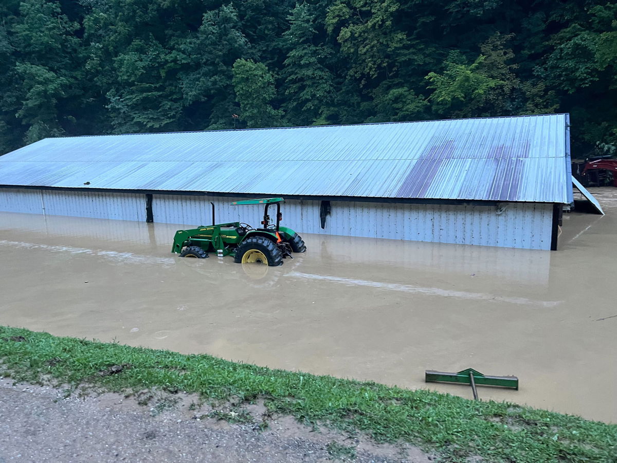 <i>Courtesy Belinda Asher</i><br/>A barn is seen submerged in floodwaters. Behind it was where Asher's home