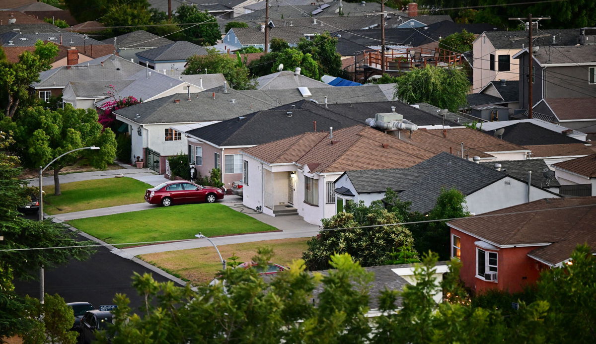 <i>Frederic J. Brown/AFP/Getty Images</i><br/>Green grass lawns are seen in front of homes in Los Angeles on July 5. Mortgage rates dropped last week