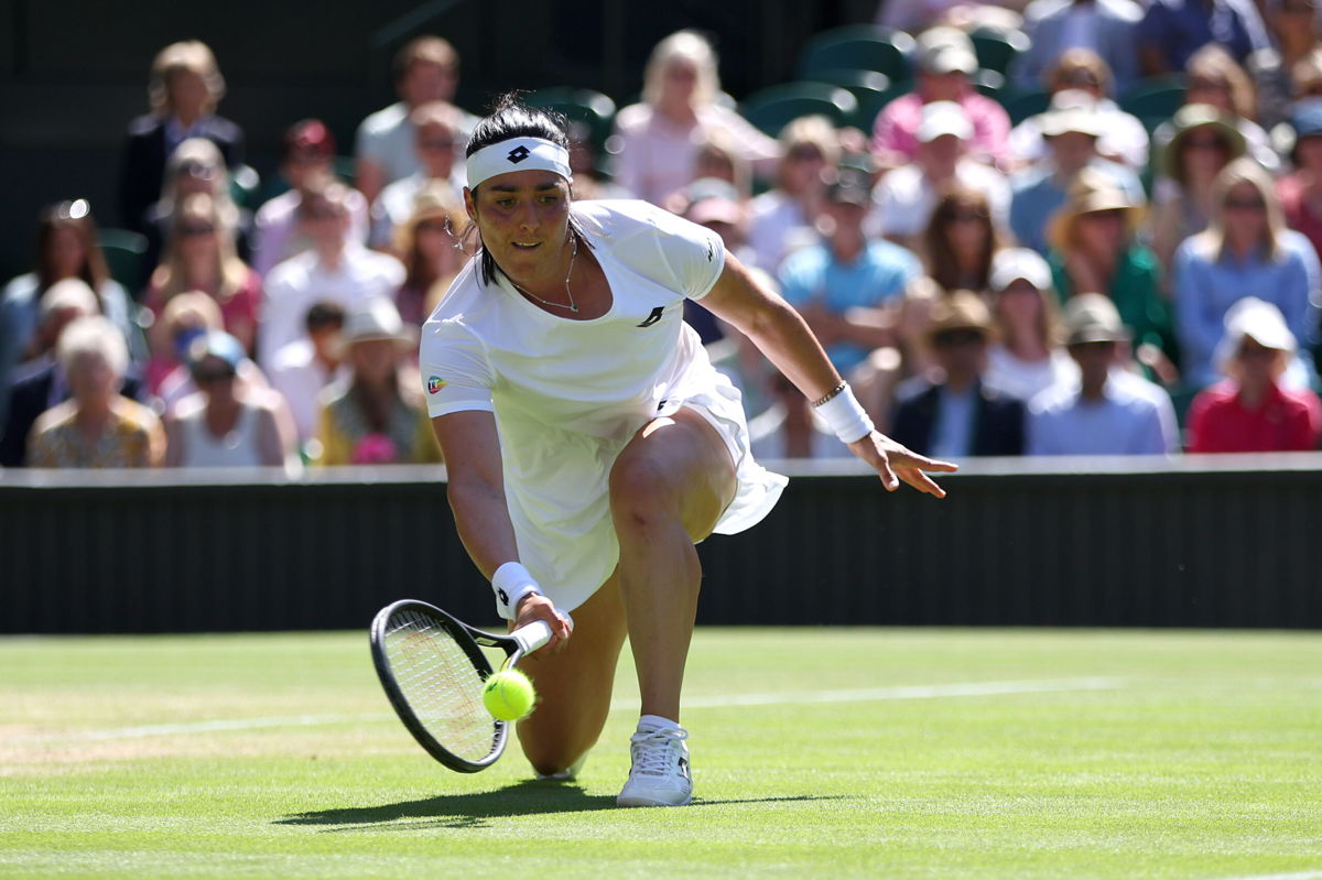 <i>Clive Brunskill/Getty Images Europe/Getty Images</i><br/>Jabeur reaches for a low forehand during her semifinal against Tatjana Maria.