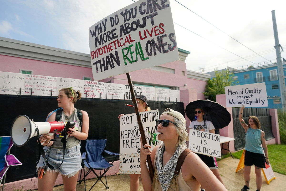 <i>Rogelio V. Solis/AP</i><br/>Abortion rights advocates stand outside the Jackson Women's Health Organization clinic in Jackson