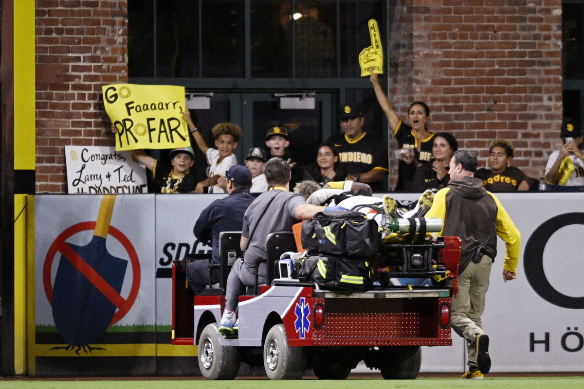 <i>Denis Poroy/Getty Images North America/Getty Images</i><br/>Jurickson Profar is cheered by fans as he is taken off by medics.