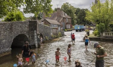 Families cool off in the River Darent on July 12 in Eynsford