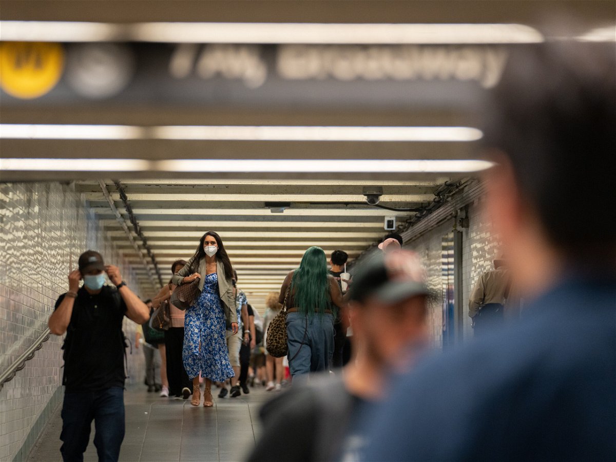 <i>Jeenah Moon/Bloomberg/Getty Images</i><br/>Some commuters don masks in New York's Times Square subway station last week.