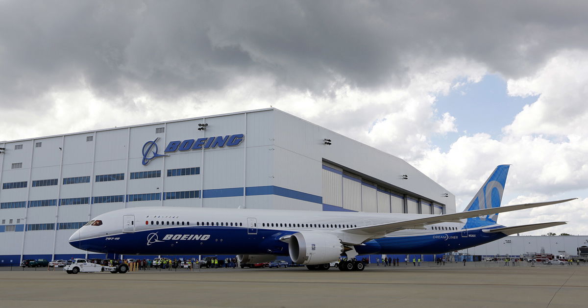 <i>Mic Smith/AP</i><br/>Boeing employees stand near the new Boeing 787-10 Dreamliner at the company's facility in South Carolina after conducting its first test flight at Charleston International Airport in North Charleston
