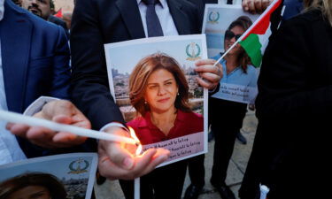 People light candles during a vigil in memory of Al Jazeera journalist Shireen Abu Akleh outside the Church of the Nativity in Bethlehem on May 16