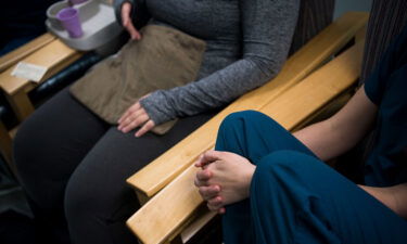 An abortion doula speaks with a patient after the procedure at Falls Church Healthcare Center in Virginia on November 24