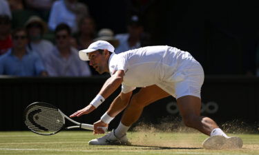 Djokovic slides for a shot against Norrie during their Wimbledon quarterfinal.
