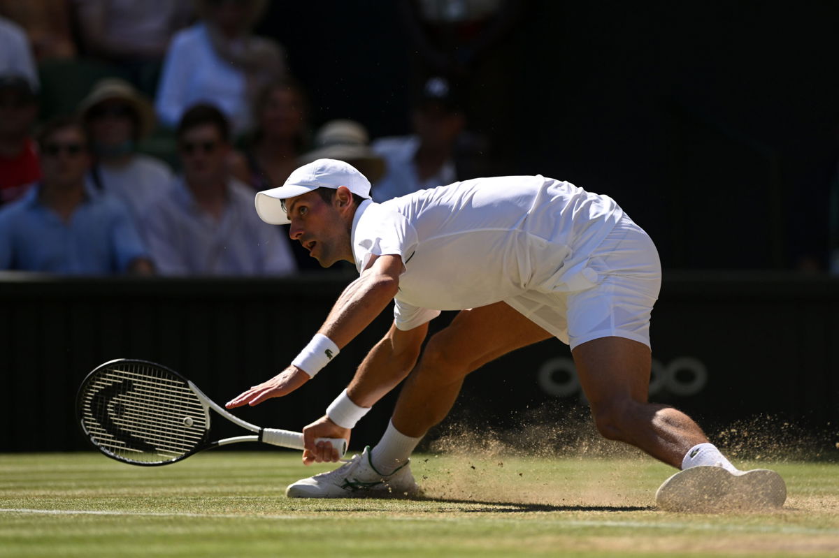 <i>Shaun Botterill/Getty Images Europe/Getty Images</i><br/>Djokovic slides for a shot against Norrie during their Wimbledon quarterfinal.