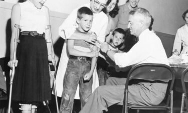 Dr. William Burgoyne gives a shot of the Salk polio vaccine to Michael Urnezis