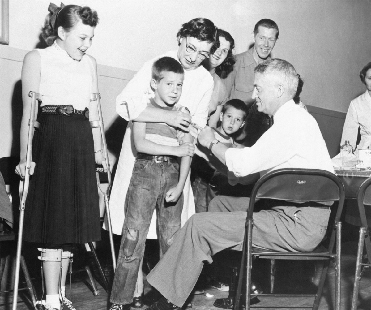 <i>Bettmann/Getty Images</i><br/>Dr. William Burgoyne gives a shot of the Salk polio vaccine to Michael Urnezis